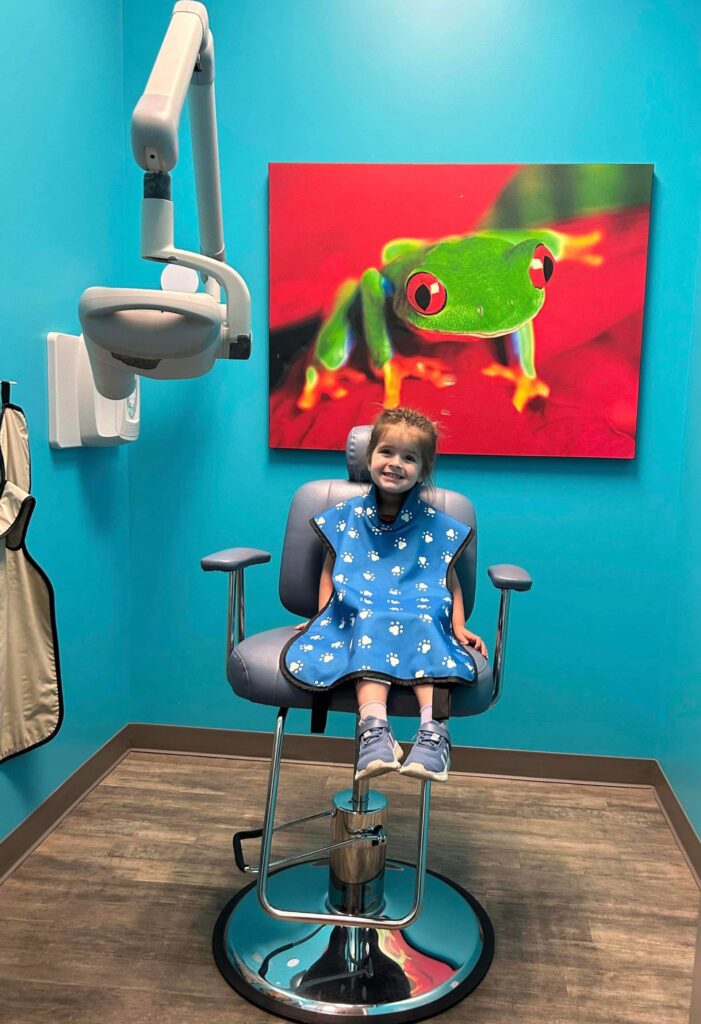 young girl smiles as she prepares for her x-ray at the Summerville Pediatric Office